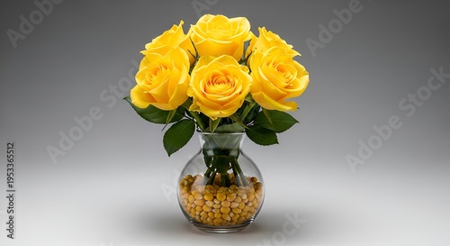 A vibrant bouquet of fresh yellow roses, artfully arranged in a clear glass vase filled with yellow