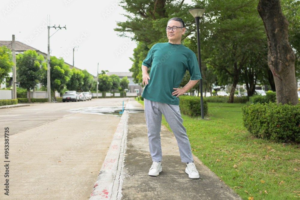 Fototapeta premium Asian senior man stretching their bodies during exercise in a park