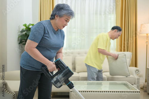 Senior couple cleaning the house together
