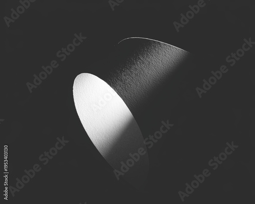 Curved surface, partially lit, emerging from darkness. Textured material. Dramatic contrast