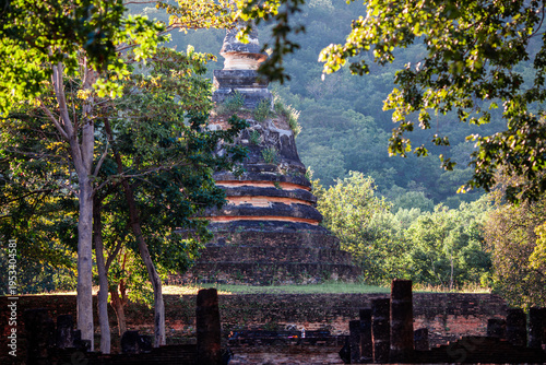 A natural backdrop of twilight sky and beautiful changing sunsets during a trip to Thailand, featuring mountains, rice fields, and temporary huts.
