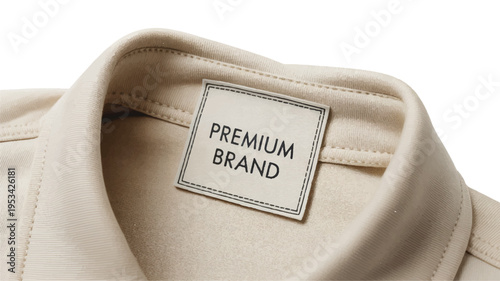 Clothing label mockup: close-up of a woven "premium brand" tag on a beige fabric collar with close-up of a woven 'premium brand' tag on the collar of