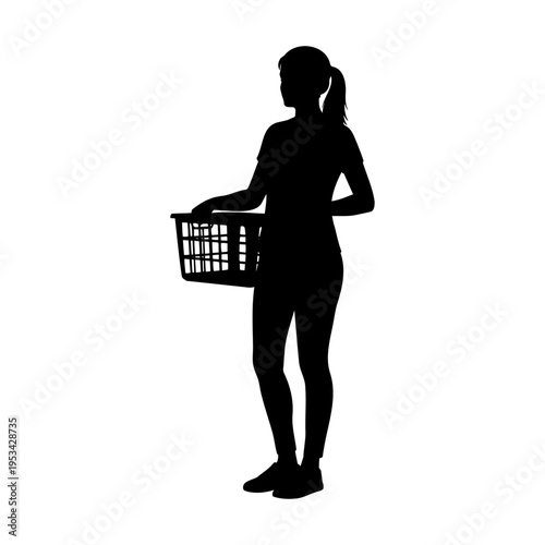 Silhouette of a young woman standing and holding a laundry basket