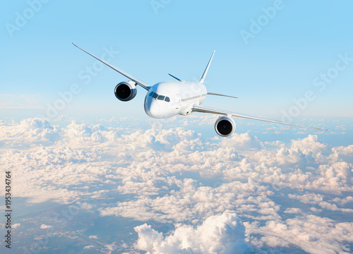 White passenger airplane flying in the sky amazing clouds in the background - Travel by air transport