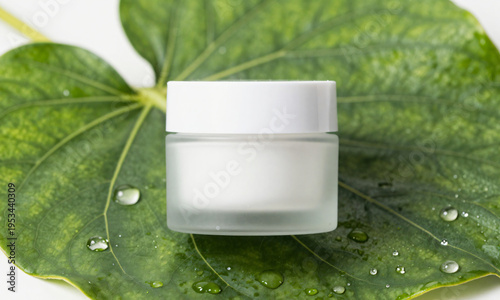 Cosmetic jar placed on giant leaf texture with dew droplets  Generative AI