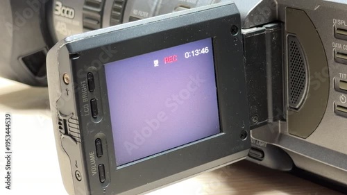A classic 3CCD camcorder initiates a new recording, showing a red 