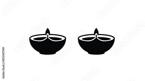 Two traditional indian oil lamps depicted in a striking black silhouette