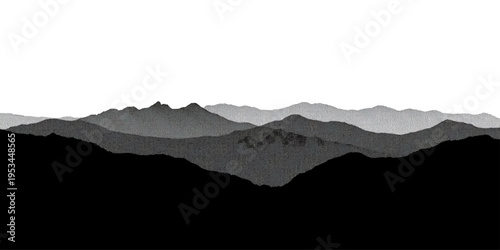 Snow covered peaks rise above a misty mountain landscape where the sunrise glows through fog and clouds over a blue forest valley