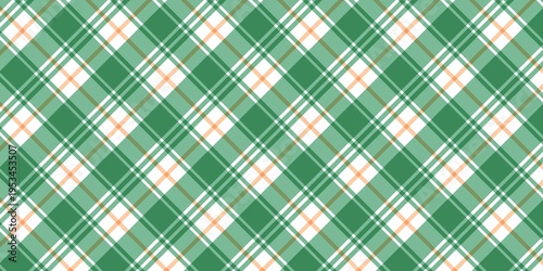 Seamless diagonal plaid pattern in green, white, and orange. Classic tartan textile background for spring, autumn, and St. Patrick's Day fashion or wrapping paper designs.