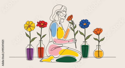 Woman sits surrounded by colorful flowers in pots indoors