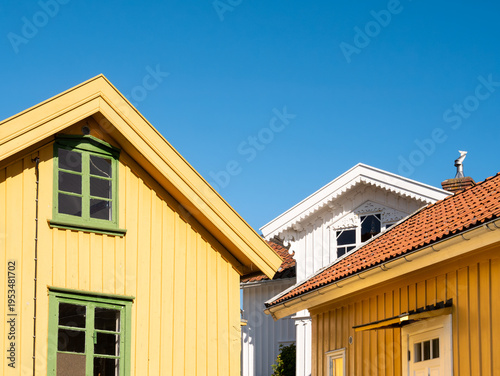 Facades of yellow and white wooden houses on Gullholmen island in Bohuslän, west coast Sweden