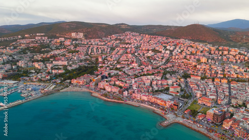 Wallpaper Mural Kusadasi, Turkey. Top-down aerial view of cruise ship at port, transition to panoramic view of city illuminated by sunset. Aerial view Torontodigital.ca