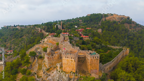 Wallpaper Mural Alanya, Turkey. Aerial view of Alanya Bay in haze with fortress wall climbing mountain slope towards Ehmedek Castle in summer.. Aerial View Torontodigital.ca