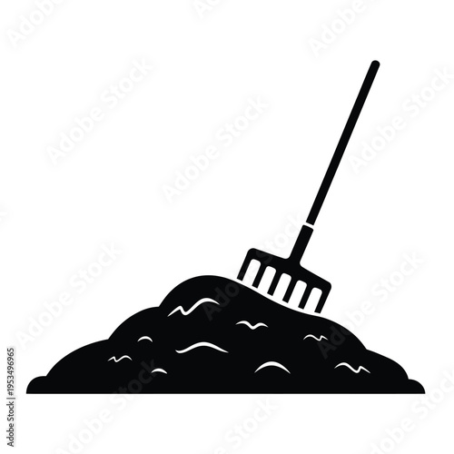 A black silhouette of a garden rake stuck in a pile of compost