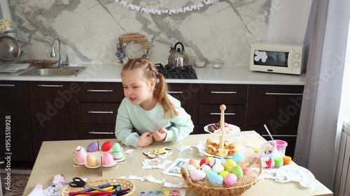 Wide shot of daughter are preparing for the Easter holiday together. Little cute girl play with rabbit glove