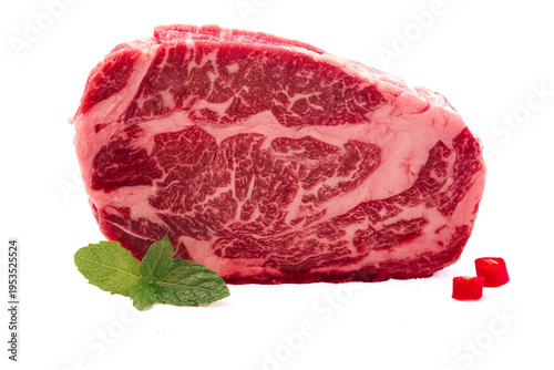 Raw Marbled Beef Steak with Fresh Mint Garnish on White Background for Cooking Photography