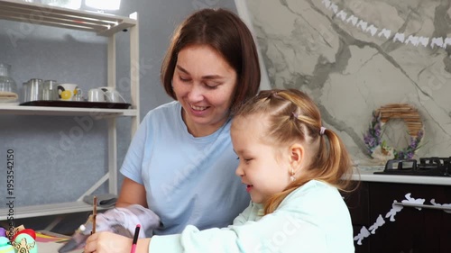 Smiling Caucasian young mother and little happy daughter playing together with paper rabbit toy-glove. Concept of Spring Festival and preschool education