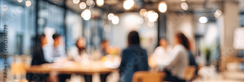 Blurred image of a diverse group of people in a modern office meeting room, collaborating around a table.