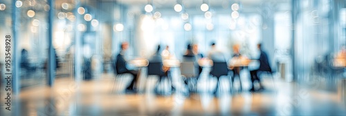 Blurred image of people in a modern office meeting room during a business discussion.