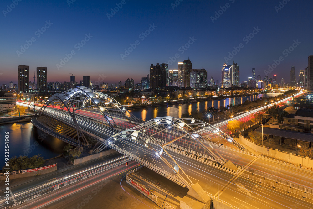 Fototapeta premium Tianjin Night View - Illuminated Bridges and City Skyline at Dusk