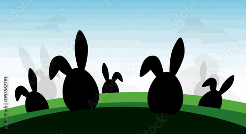 Silhouettes of rabbits on a green hill.