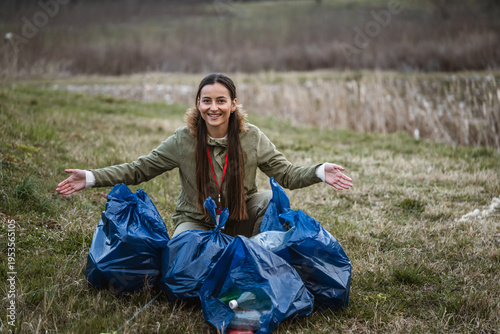 Photography Young woman volunteering cleaning up plastic waste outdoors