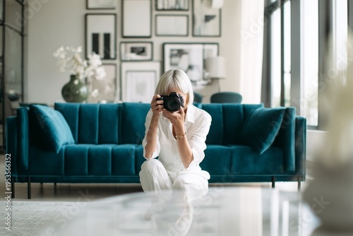 Woman taking photo in modern living room
