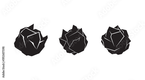 Three black and white geometric shapes resembling rocks or crystals with sharp edges and white lines on a white background  abstract forms