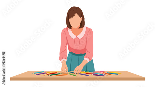 Creative Arrangement: A person attentively arranges colored pencils on a wooden table, emphasizing focus and detail.