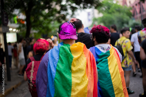 People celebrating lgbtq pride with rainbow flags at parade