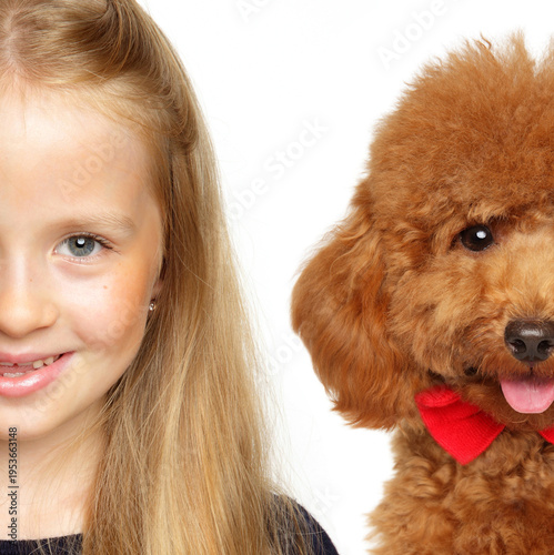 Young girl with blonde hair smiling next to toy poodle