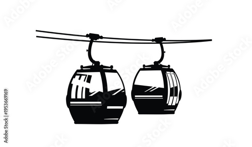 Silhouette of two cable car cabins suspended from cables