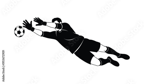 Soccer goalkeeper diving to catch ball in silhouette