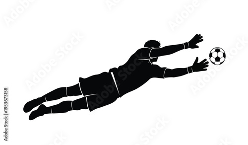 Soccer goalkeeper diving to catch ball in silhouette