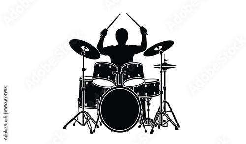 Silhouette of a drummer playing a drum set with sticks raised