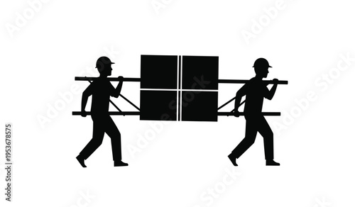 Silhouette of two workers carrying a large panel or window