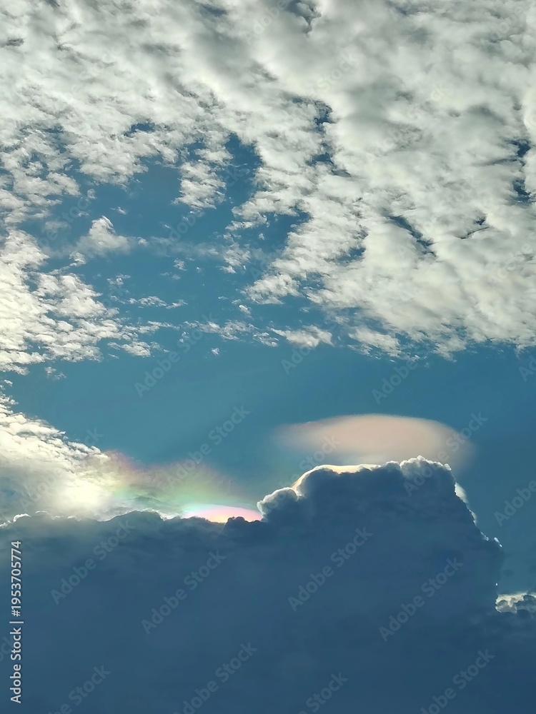 Fototapeta premium Beautiful iridescent pileus cloud with spectral colors in the summer sky