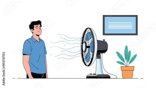Young man stands comfortably in his room in front of a rotating electric desk fan to enjoy the cool breeze on a hot summer day.