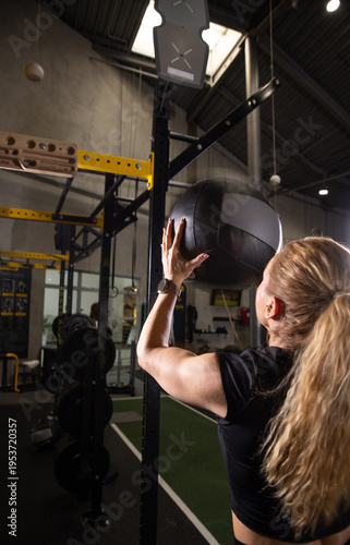 Fitness and health concept. A fit young woman works out in a modern gym. Athletic man doing exercise.