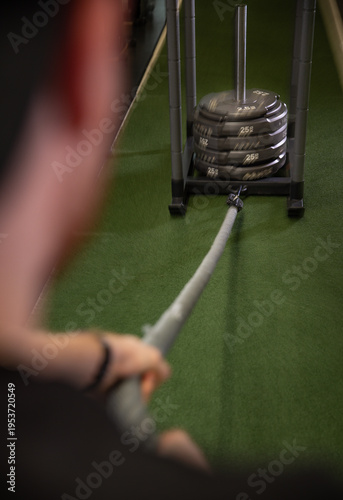 Fitness and health concept. A fit young man works out in a modern gym. Athletic man doing exercise.