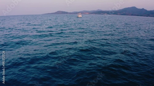 Cinematic Drone Reveal Shot Over Dark Sea Toward Luxury Yacht at Dusk