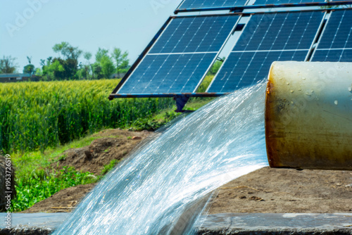 Tableau sur toile A sustainable farming setup shows a solar-powered tube well irrigating a wheat f