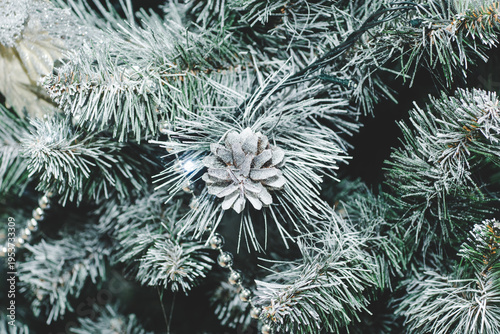 The Christmas tree is decorated with silver-colored toys.