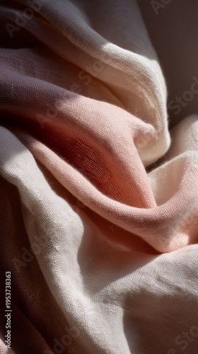 Close-up of softly draped pink and white fabric, capturing intricate woven textures and gentle light reflections.
