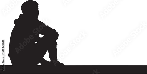 Silhouette of a man sitting alone in darkness