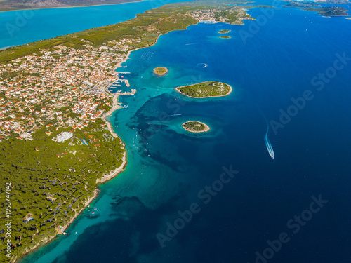 Aerial view of the Croatian coast where the turquoise Adriatic sea meets the land, the Crvena Luka visible, Biograd na Moru, Zadarska zupanija, Croatia.