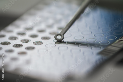 Highresolution Image Showing Probe Placing Matrix Spots On Metallic Surface For Mass Spectrometry Examination