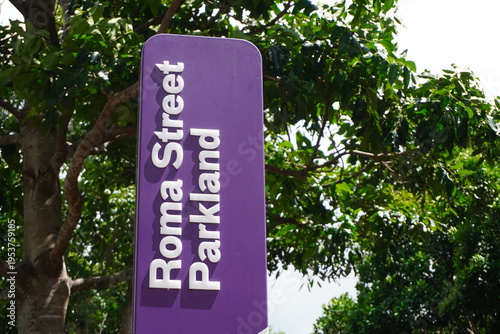 Roma Street Parkland sign against green trees in Brisbane Australia
