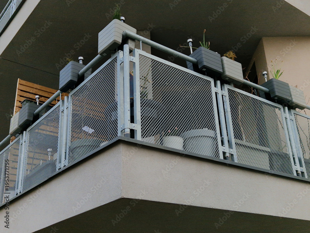 Obraz premium modern balcony railing with expanded metal infill. This type of infill is popular in architecture for its combination of safety, airiness and ability to provide privacy without completely blocking the
