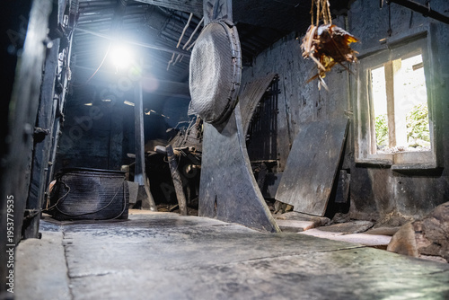 Foto Lanyu, Taiwan: Traditional dried flying fish hanging from the smoke-blackened wooden beams inside a Tao underground house